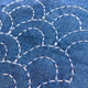 Close-up of blue fabric with white stitching patterns