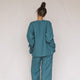 back of woman wearing tea linen jacket and pants