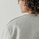 cropped image of the back of a woman's shoulder showing the seams of the denim artist jacket
