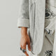 cropped image showing the cuff and front panel of a woman wearing a denim artist jacket