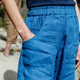 Person wearing blue pants with a blurred background
