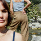 Two women standing outdoors with a natural landscape in the background