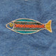 Embroidered fish design on denim fabric