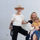 image of a woman wearing the natural hemp crop top standing next to a younger woman holding a small child