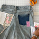 Patchwork jeans with floral and solid patches on a grid background
