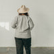 back view of woman wearing the denim artist jacket and a brimmed hat